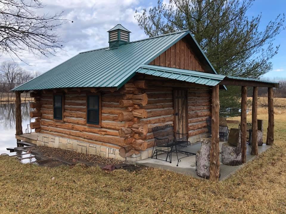 Full-log cedar cabin with metal roof and real notched corners